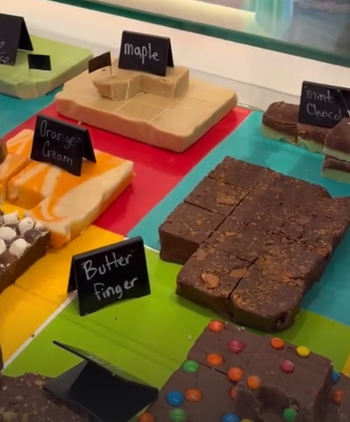 Assorted chocolate bars on a colorful display with labels indicating flavors.